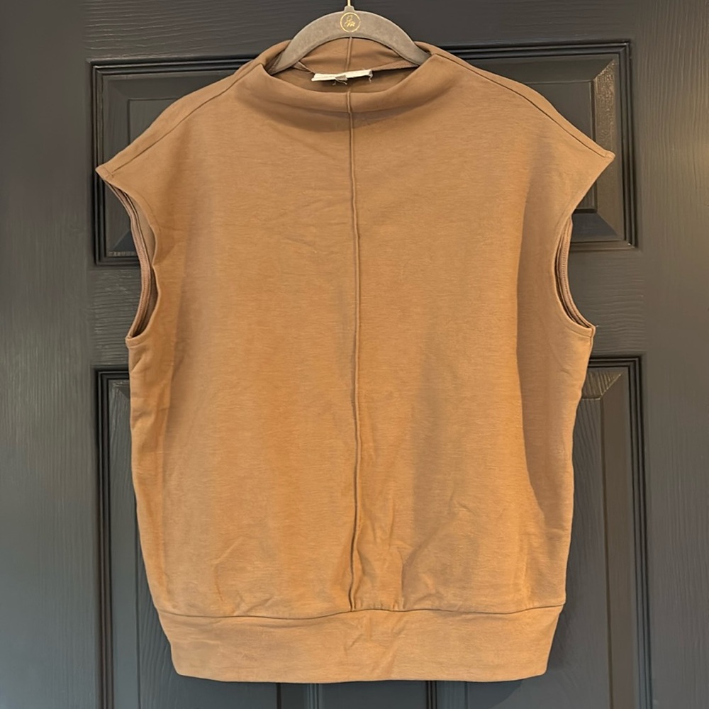 Super cute top with a cute detail down the front kind of a mock neck